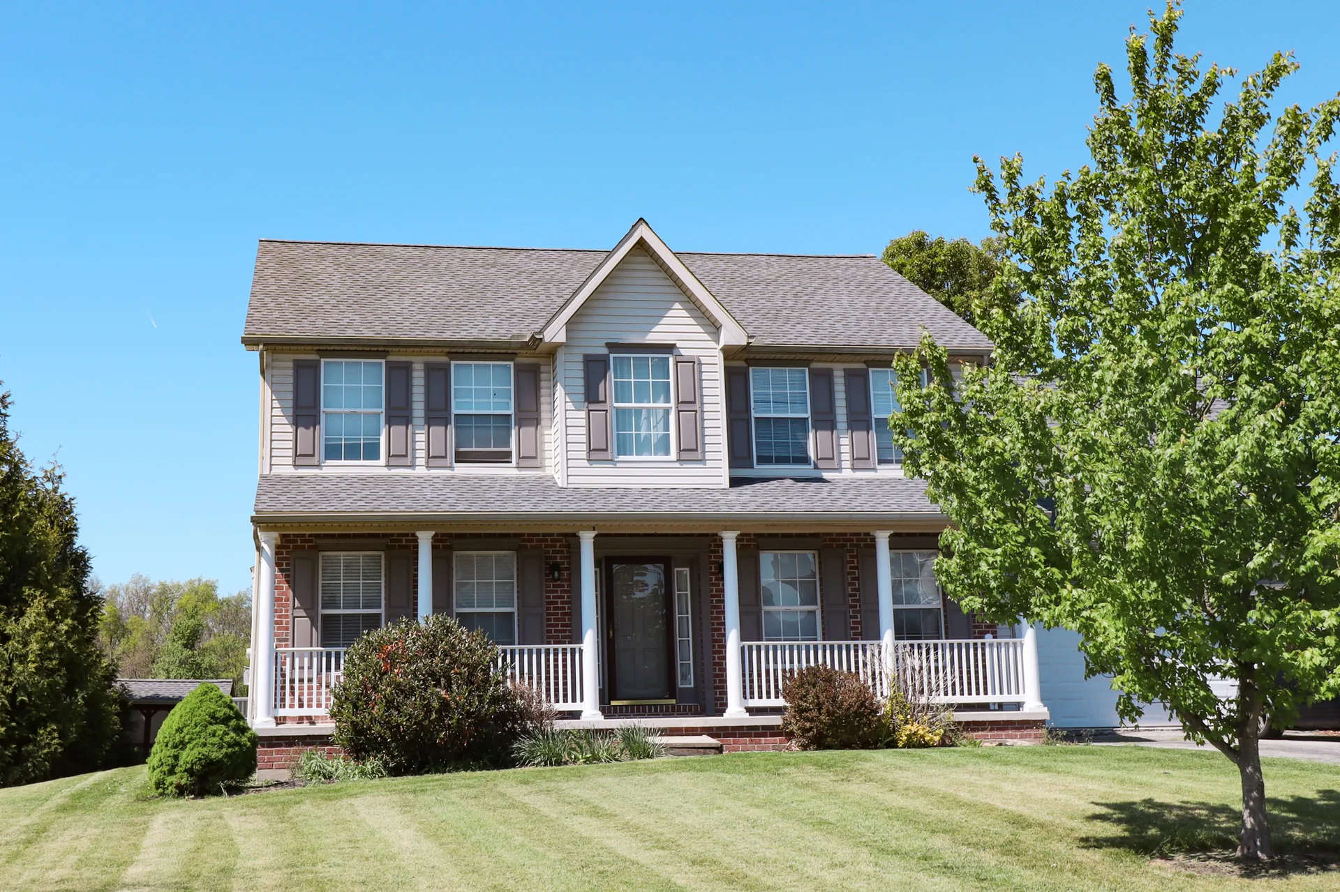 Completed roof on a beige colonial home in York County, PA by Cool Water Roofing