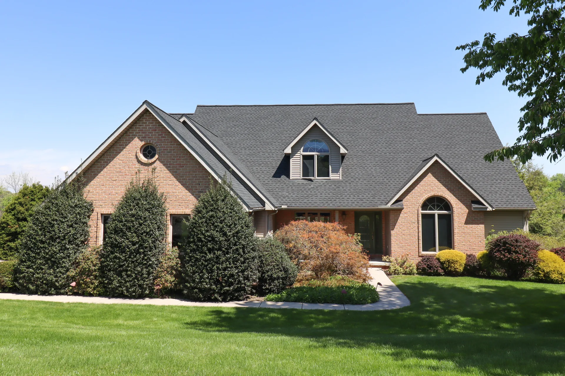 Completed roof on a brick colonial with a dormer in York County, PA by Cool Water Roofing