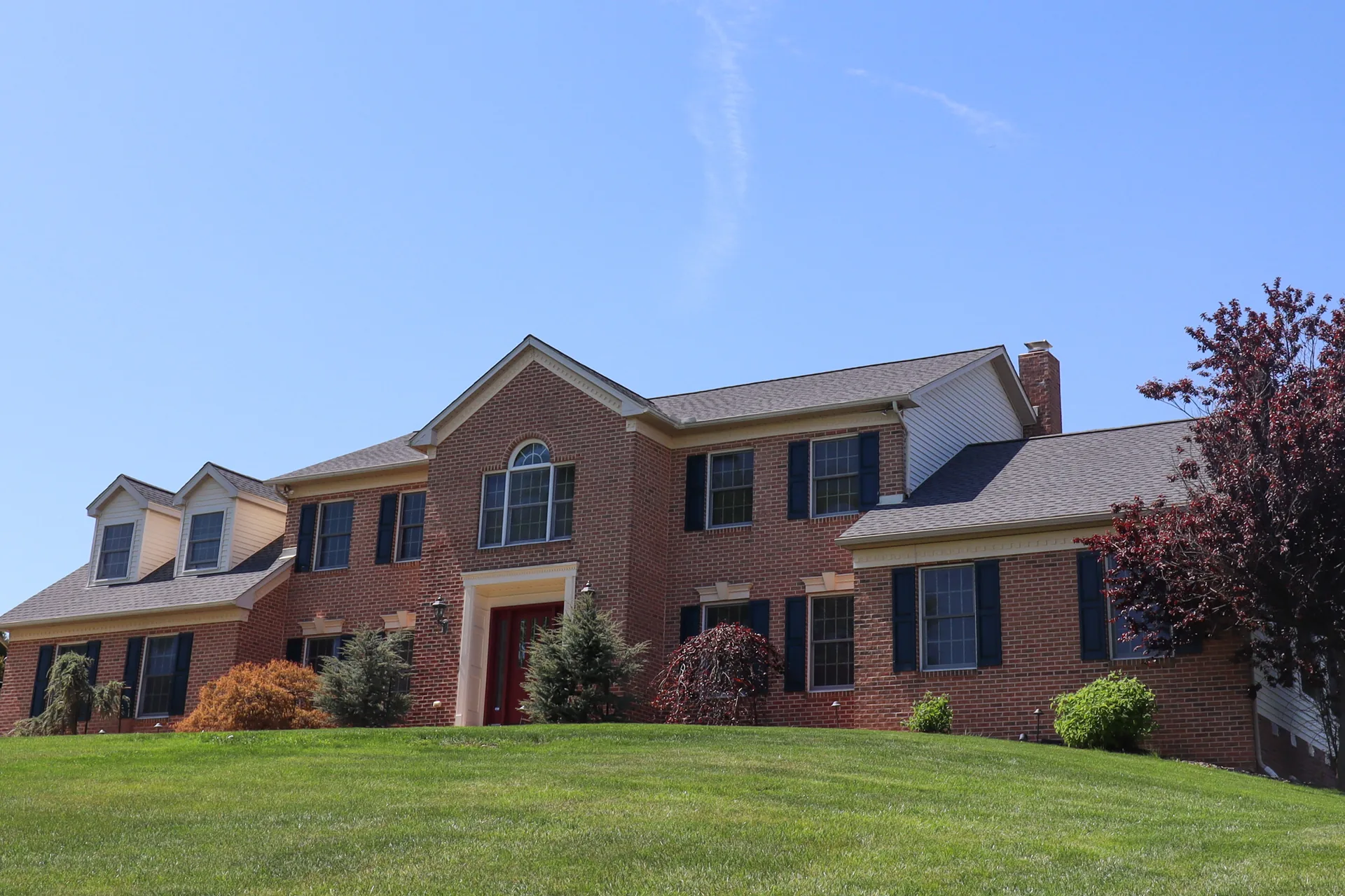 Completed roof on a large brick colonial with dormers in York County, PA by Cool Water Roofing
