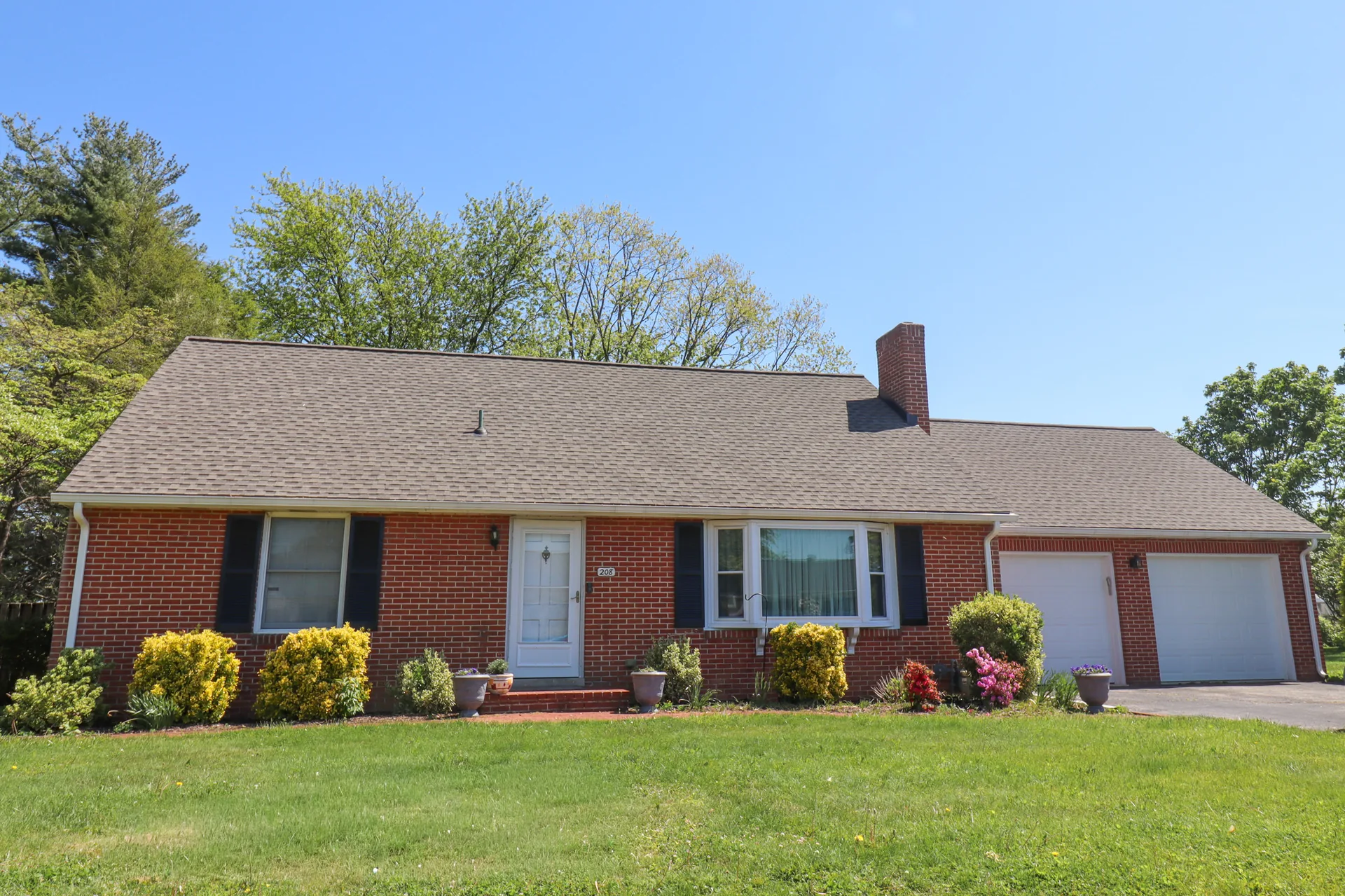 Completed roof on a brick ranch with a bay window in York County, PA by Cool Water Roofing